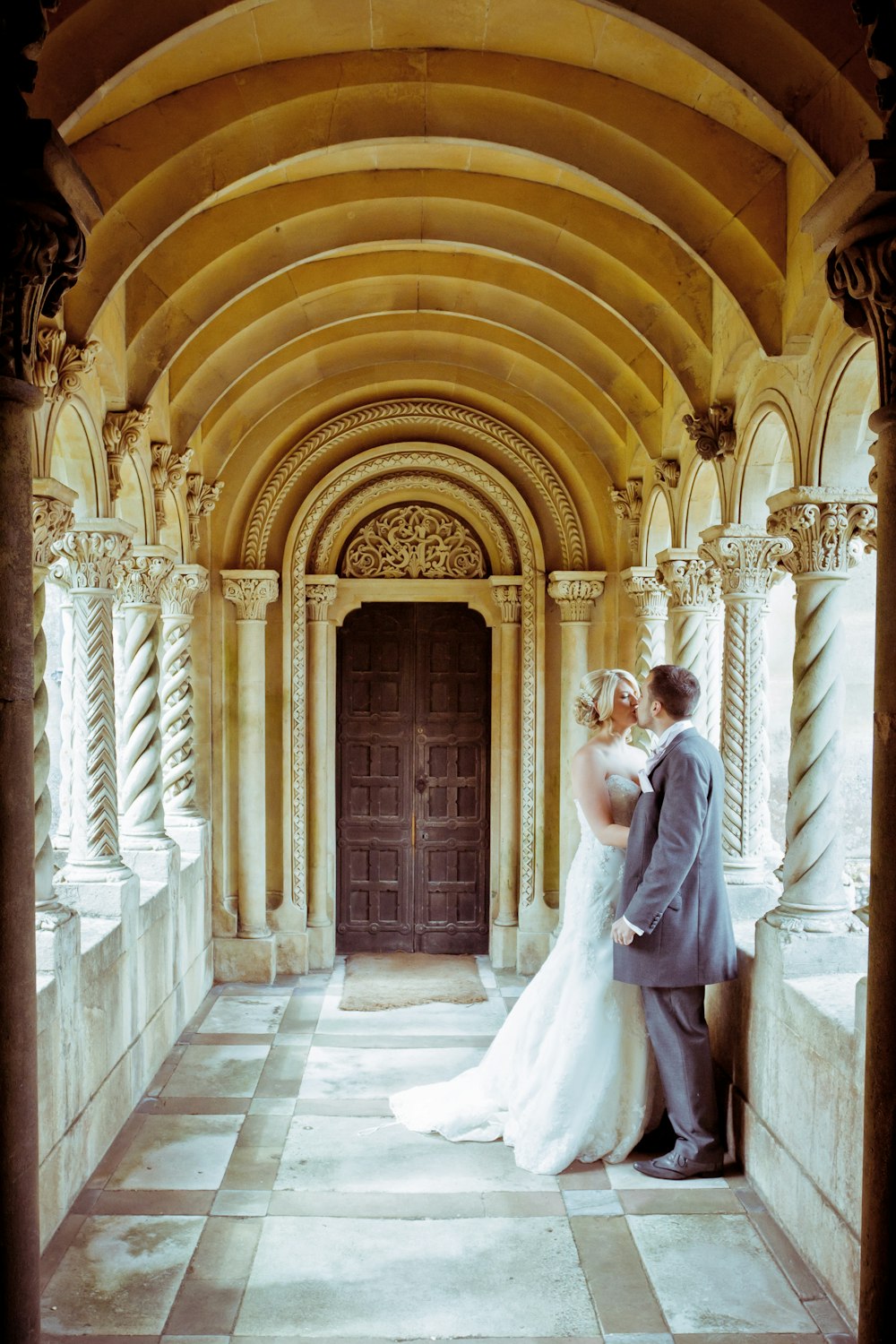 bride and groom standing on white floor tiles