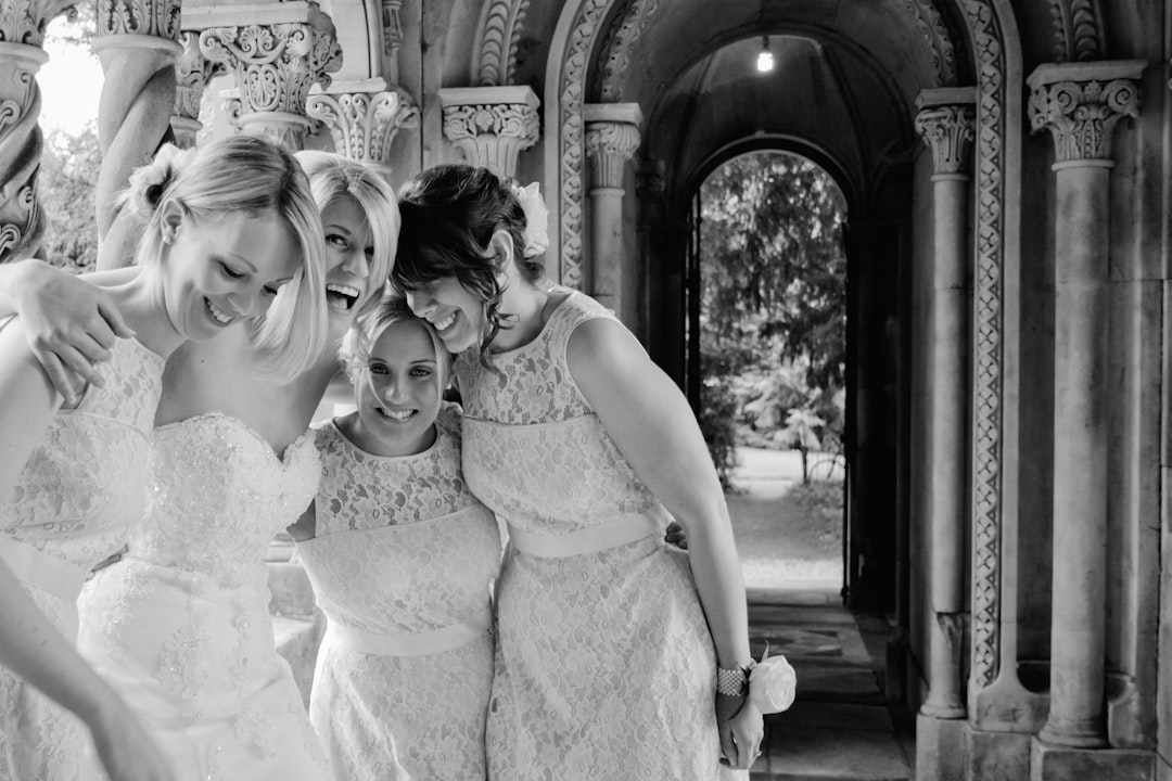 grayscale photo of 2 girls wearing white floral dress