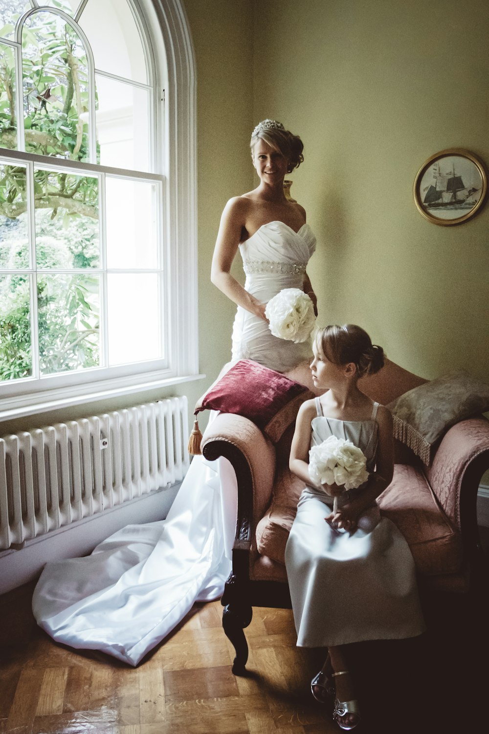 woman in white wedding dress sitting on bed