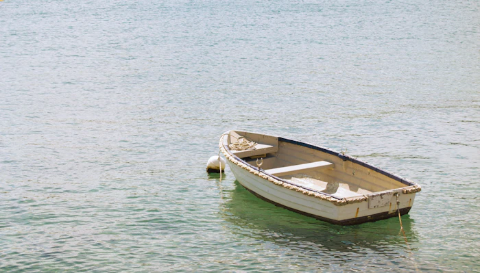 A small wooden boat on calm, clear water