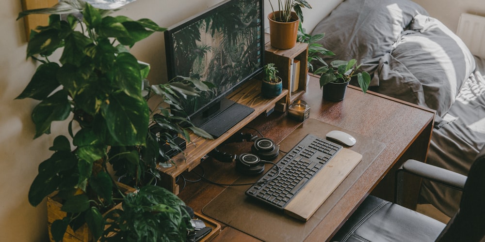 silver imac with keyboard and mouse on brown wooden table