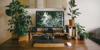 black flat screen computer monitor on brown wooden desk