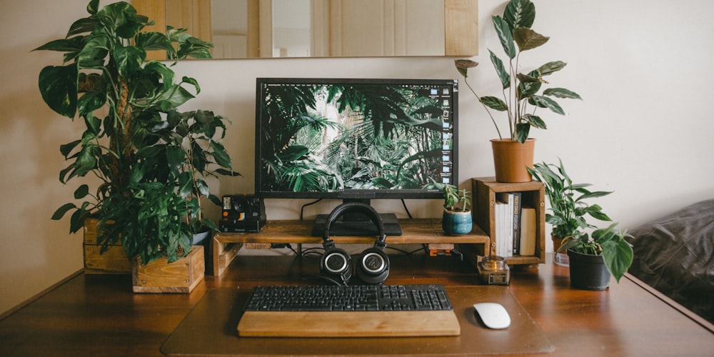 black flat screen computer monitor on brown wooden desk