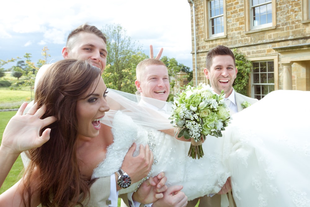 woman in white wedding gown holding bouquet of flowers