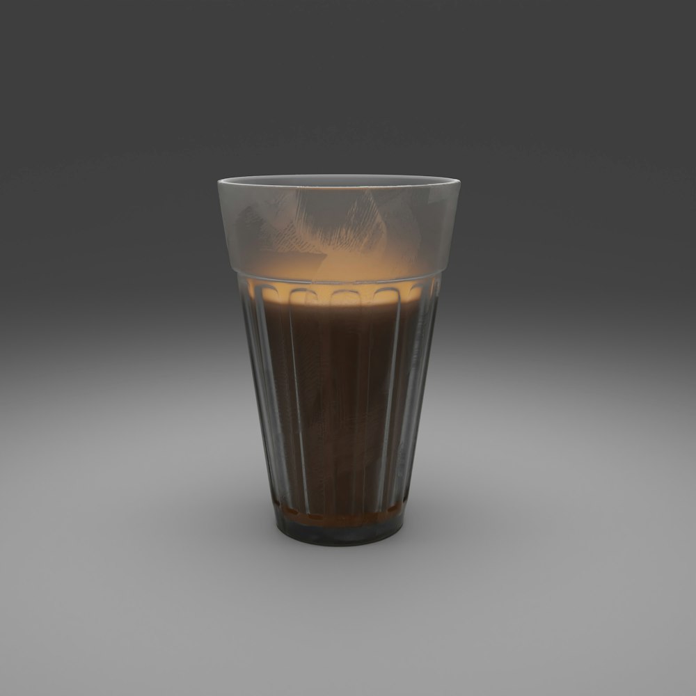 clear drinking glass with brown liquid