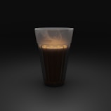 clear drinking glass with brown liquid