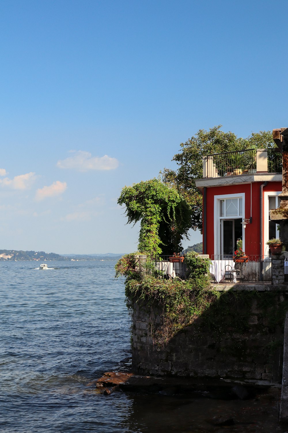 red and white concrete building near body of water during daytime