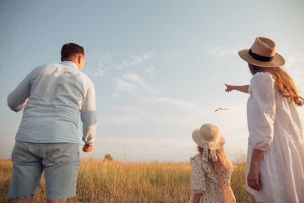A happy family enjoying outdoor playtime with drones and helicopters