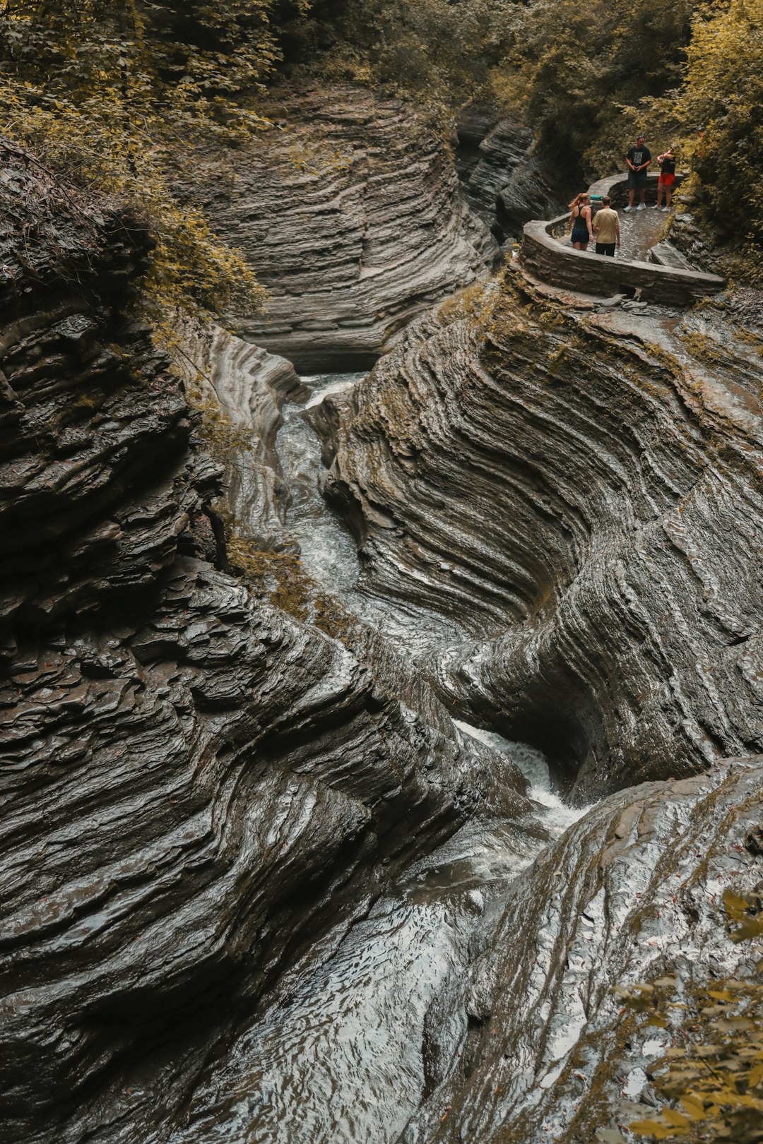 person in black jacket sitting on rock formation during daytime