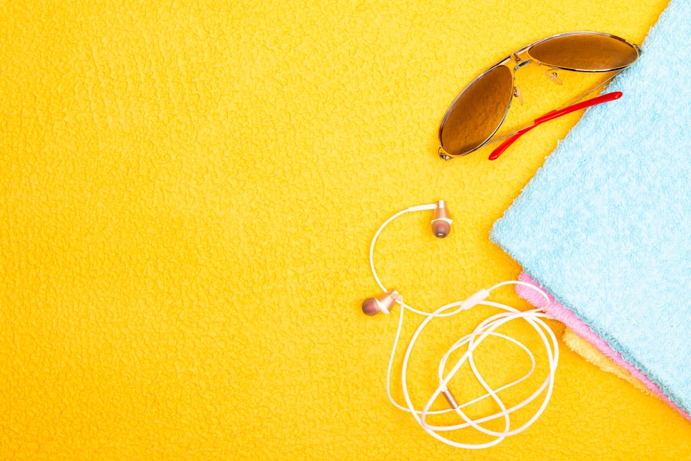 white earbuds on yellow textile