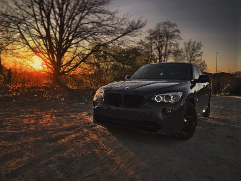 black bmw car on road during sunset