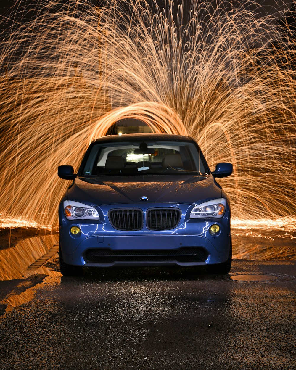 blue bmw car on brown dirt road during daytime