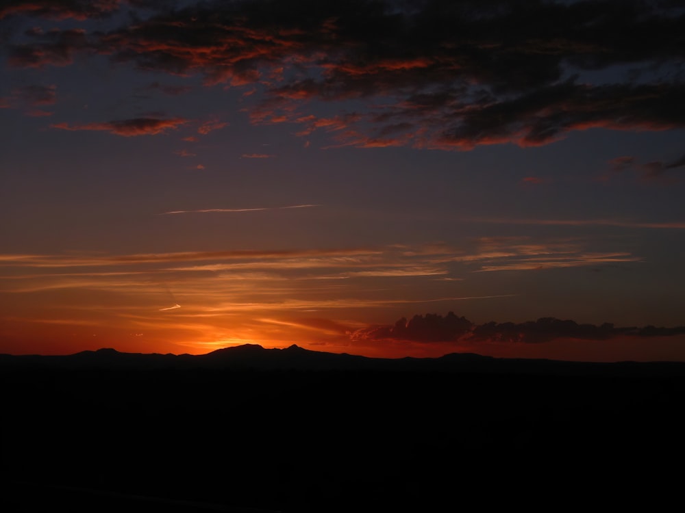 silhouette of mountain during sunset