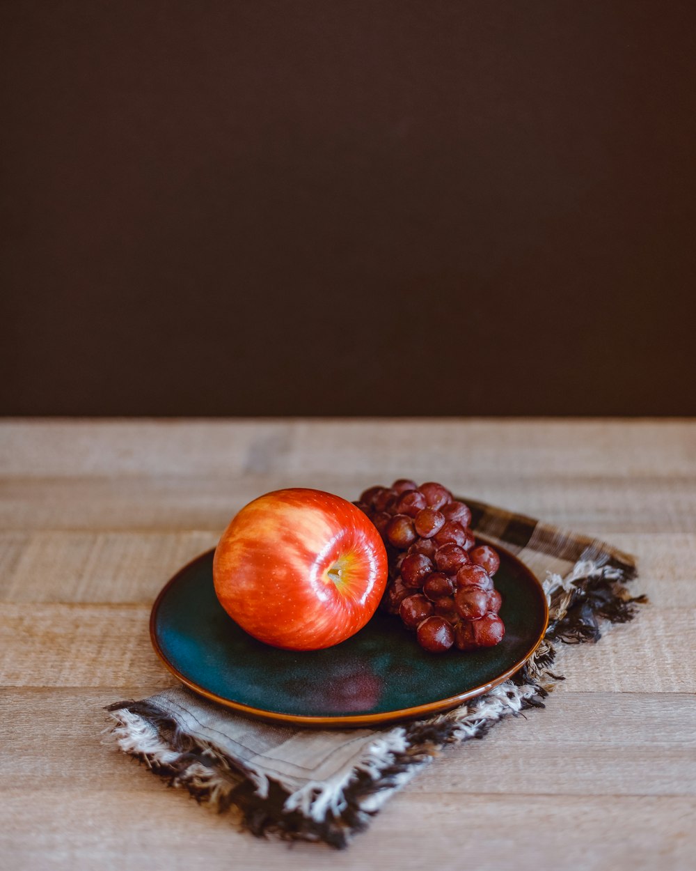 red tomato on blue and white ceramic plate