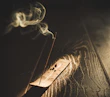 Traditional incense burners releasing wisps of fragrant smoke in a cozy room.