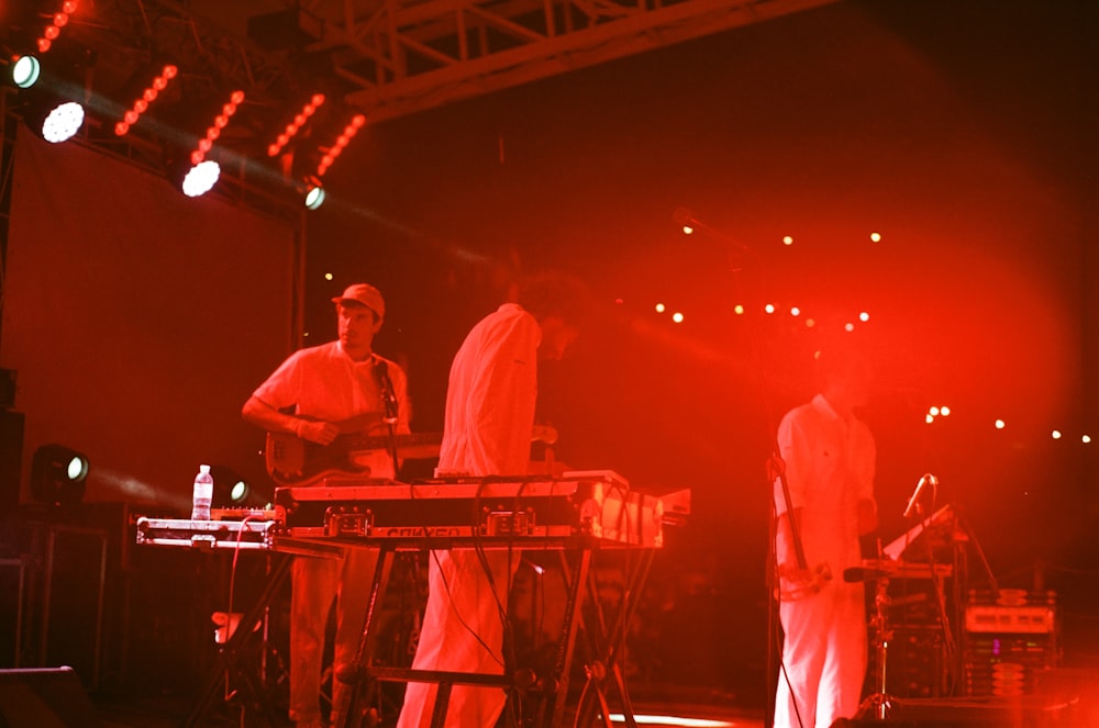 man in white long sleeve shirt standing on stage