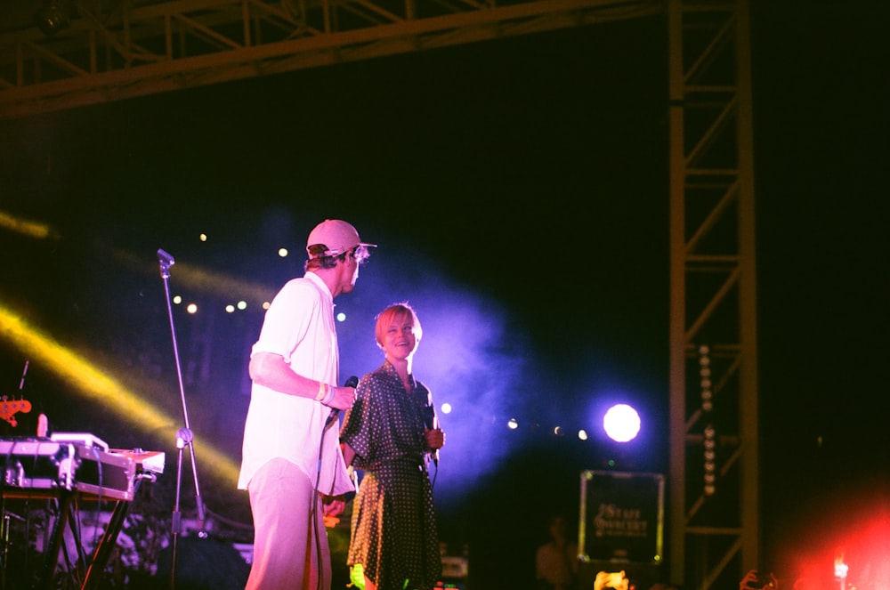 man and woman standing on stage