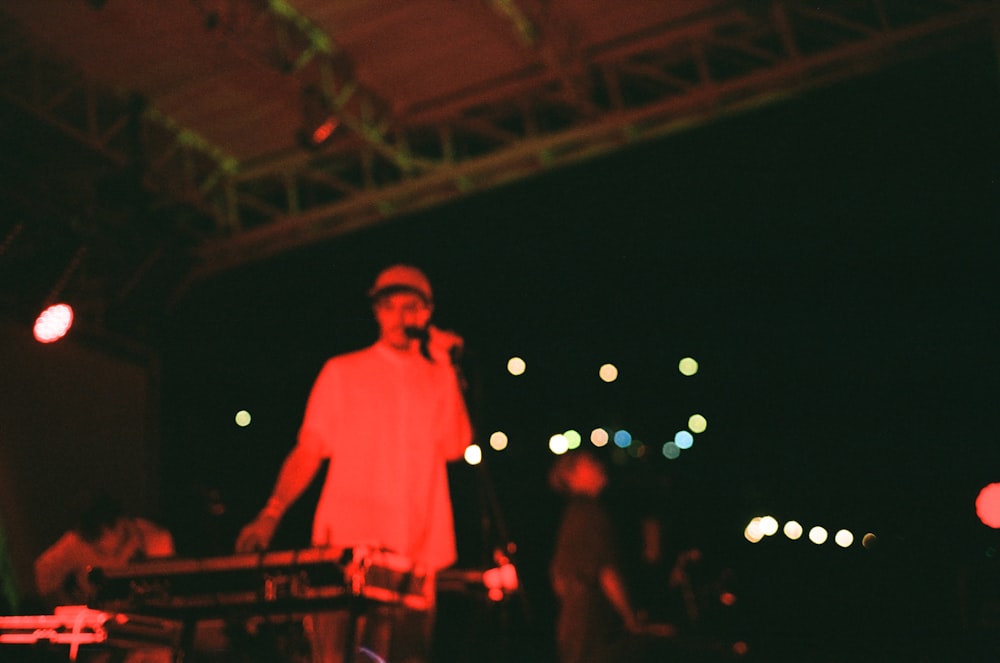 man in white dress shirt standing on stage