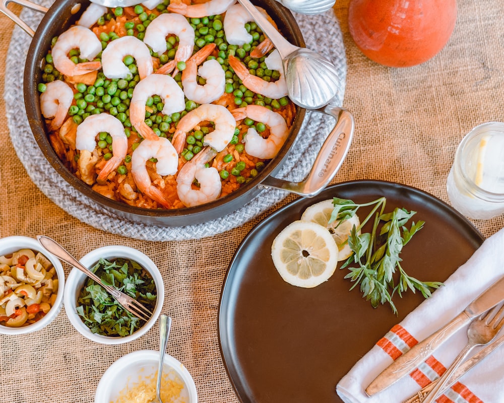 pizza with green leaf vegetable on brown ceramic plate