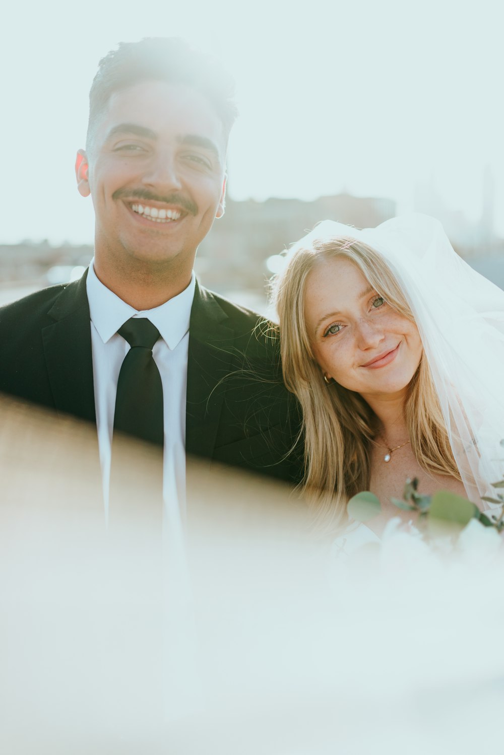 man in black suit jacket beside woman in white wedding dress