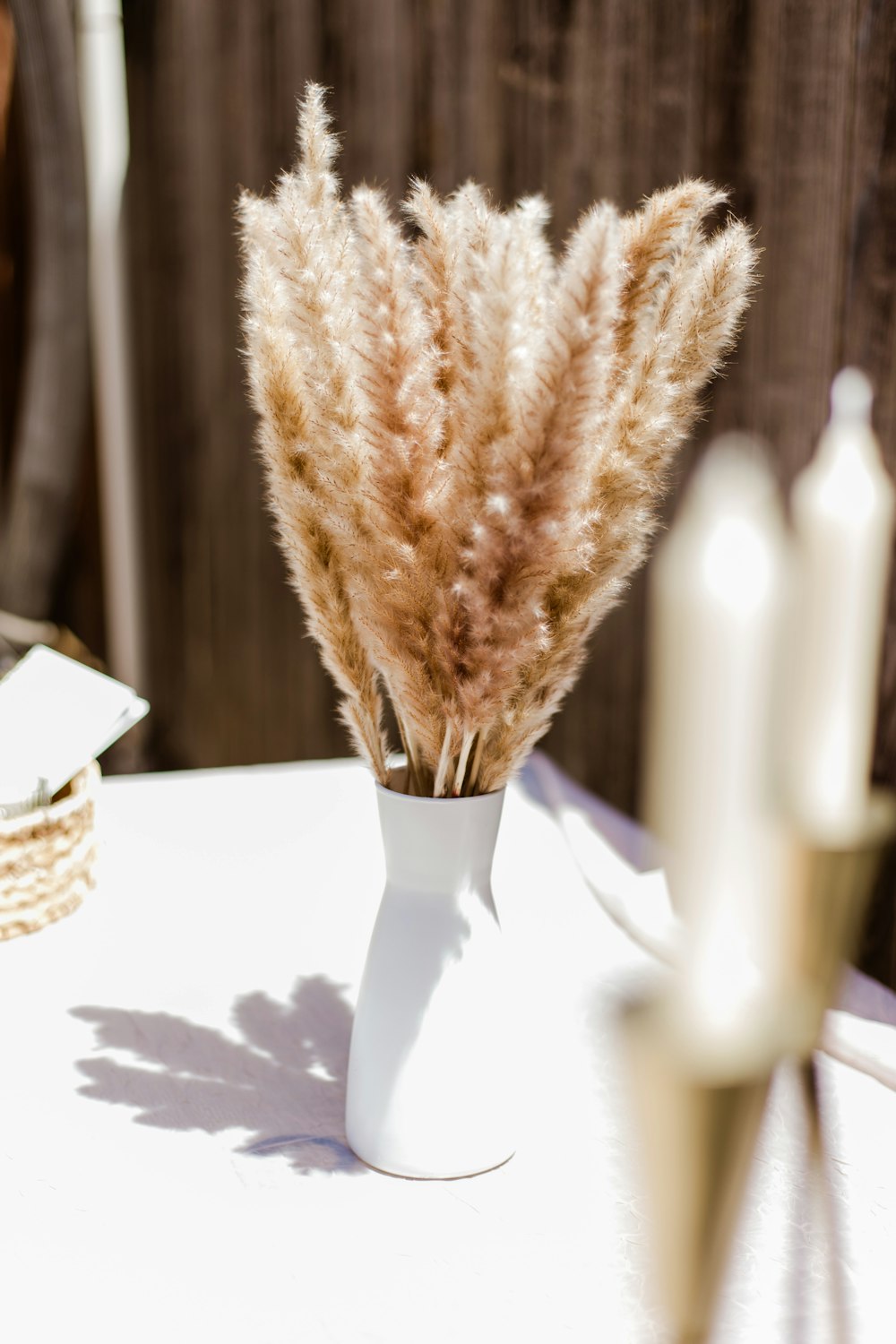 brown and white woven basket on white table