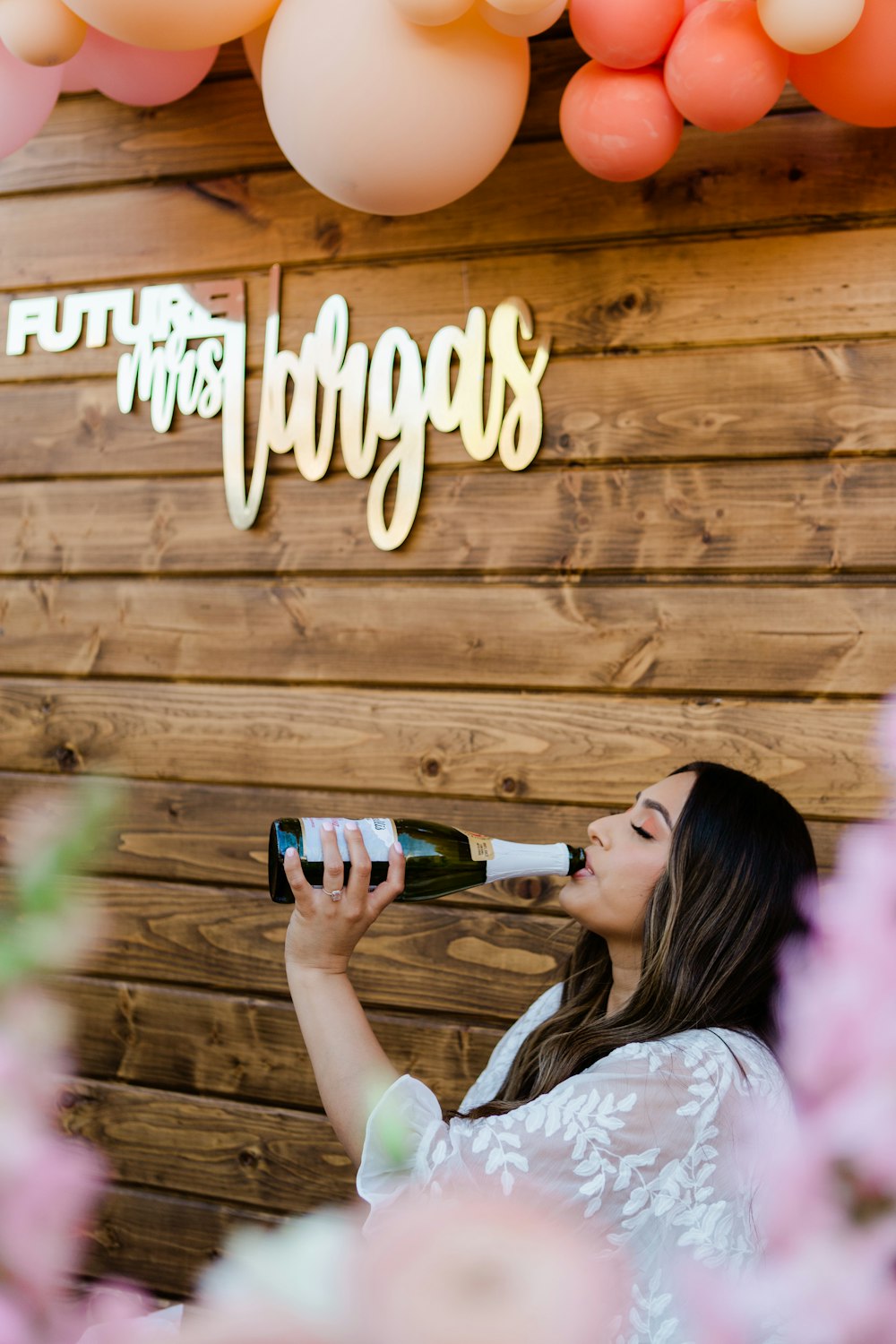 woman in white shirt drinking beer