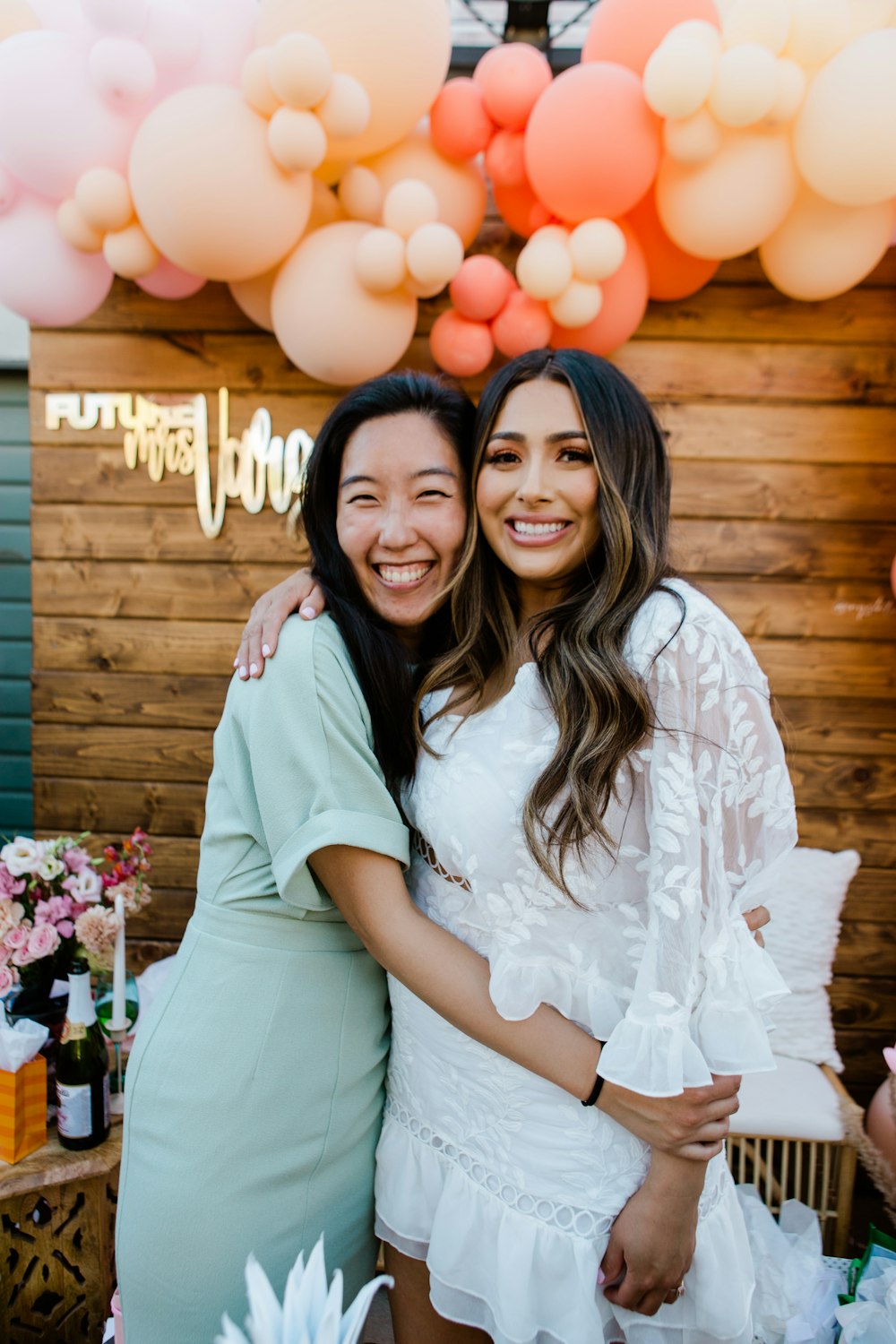 woman in white shirt smiling beside woman in white shirt