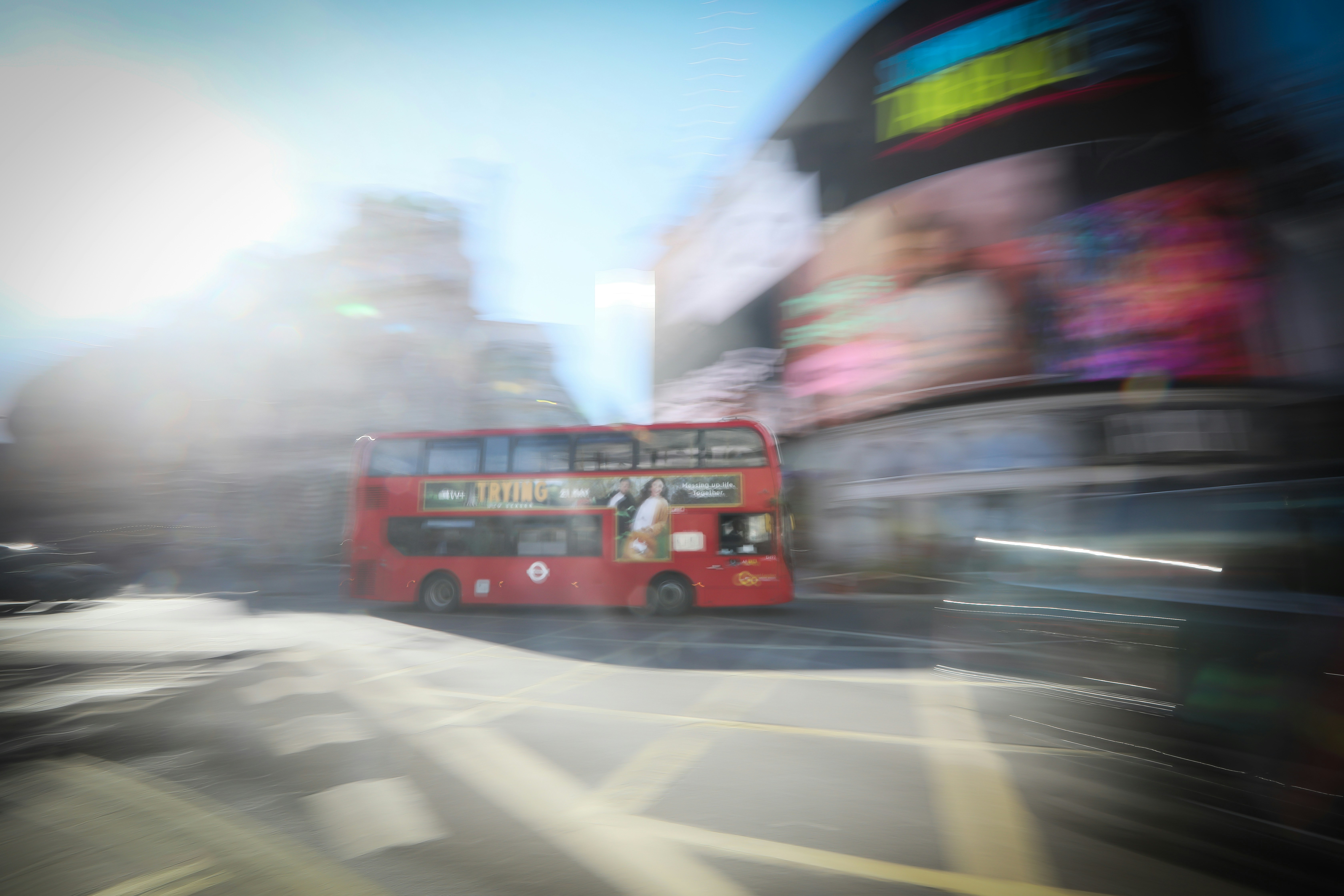 red bus on road during daytime
