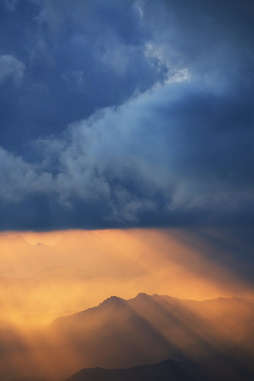 white clouds over mountains during daytime