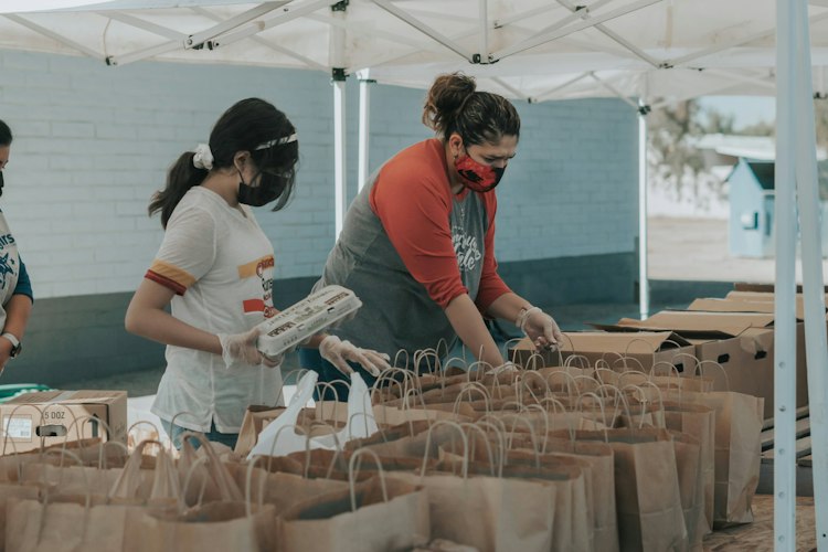 A volunteer sorting donation boxes at a community center