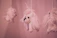 Close-up of a delicate felt mobile featuring soft pastel bears hanging above a crib.