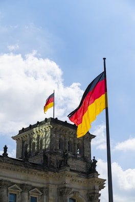 Campus building with German flags fluttering in the breeze.