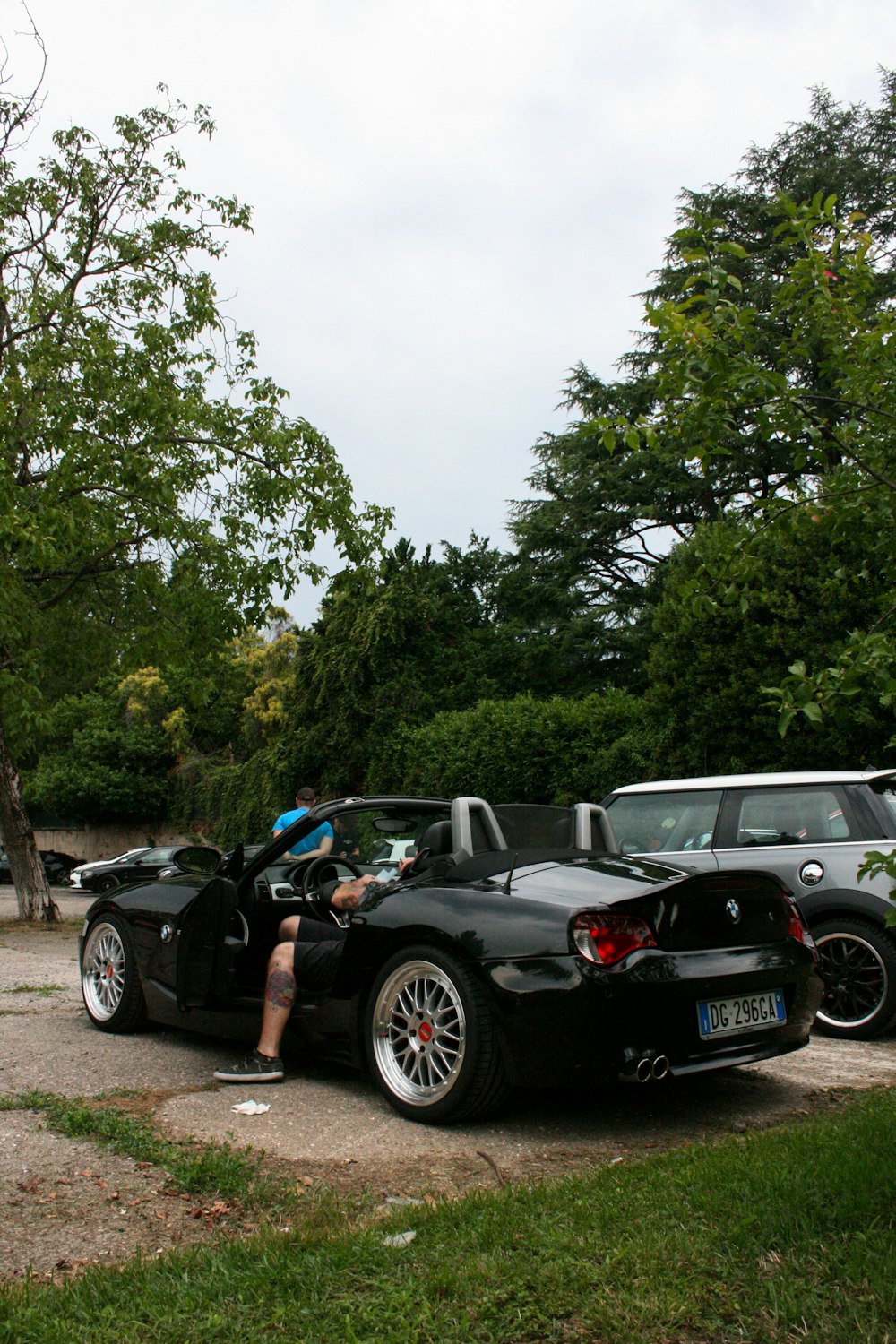 black bmw m 3 parked on gray dirt road during daytime