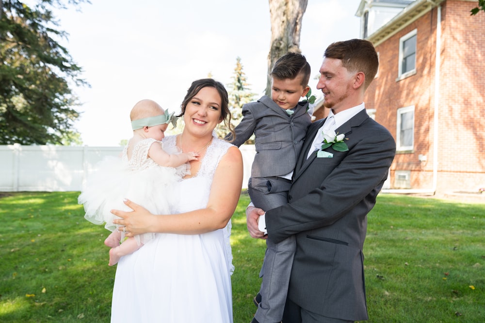 man in black suit and woman in white wedding dress