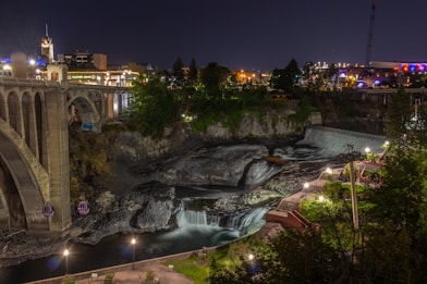 water falls near bridge during night time