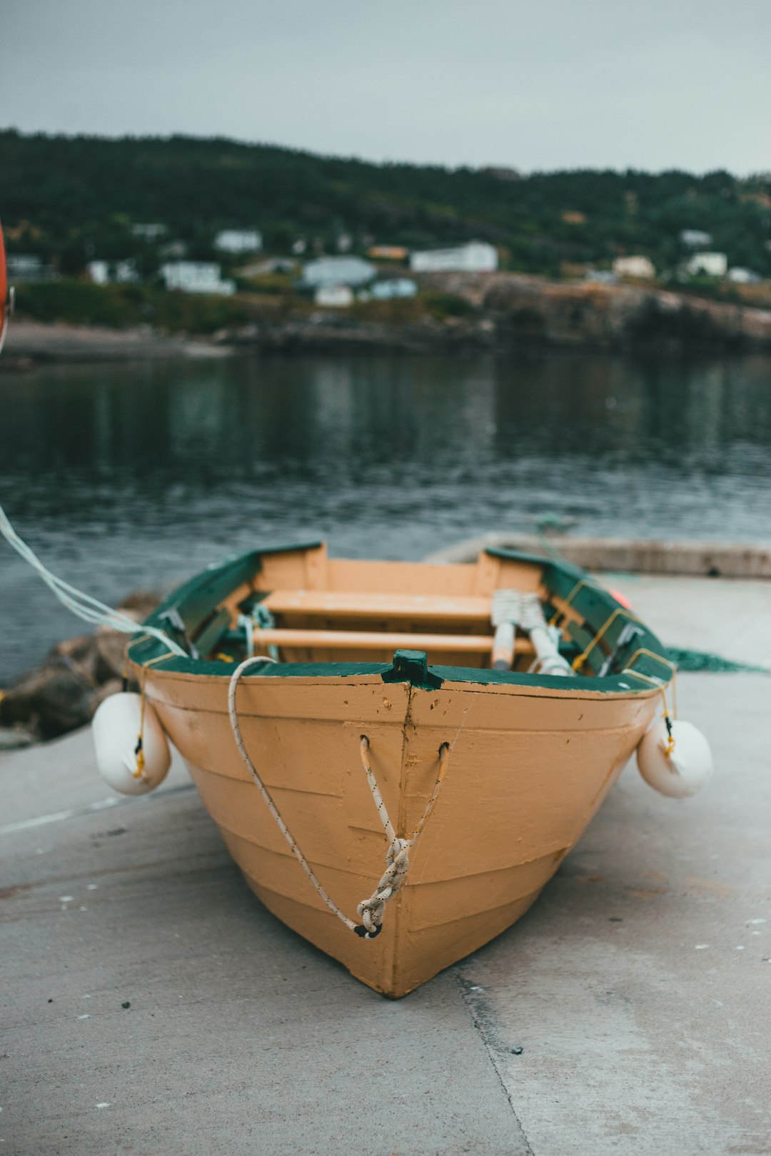 brown and green boat on water during daytime