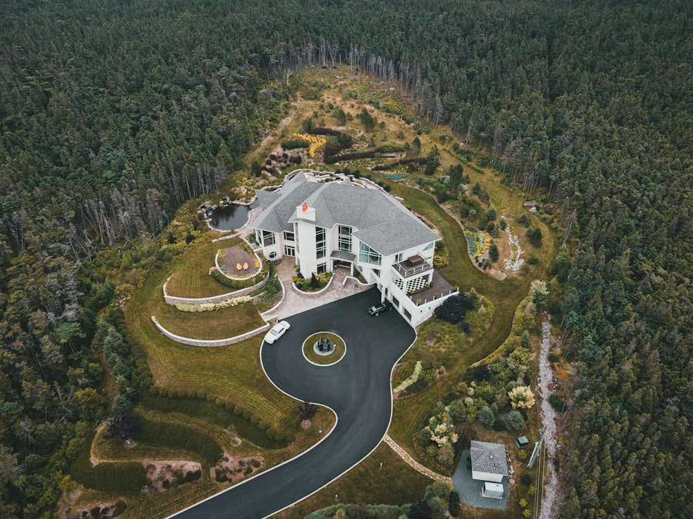 aerial view of green trees and white house during daytime