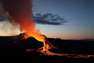 Sunset view over the Piton de la Fournaise volcano with glowing lava flows.