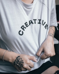 Close-up of hands carefully printing a creative design onto a soft cotton tee.