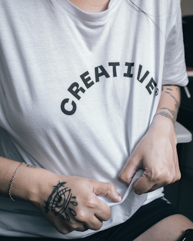 Close-up of hands carefully printing a creative design onto a soft cotton tee.