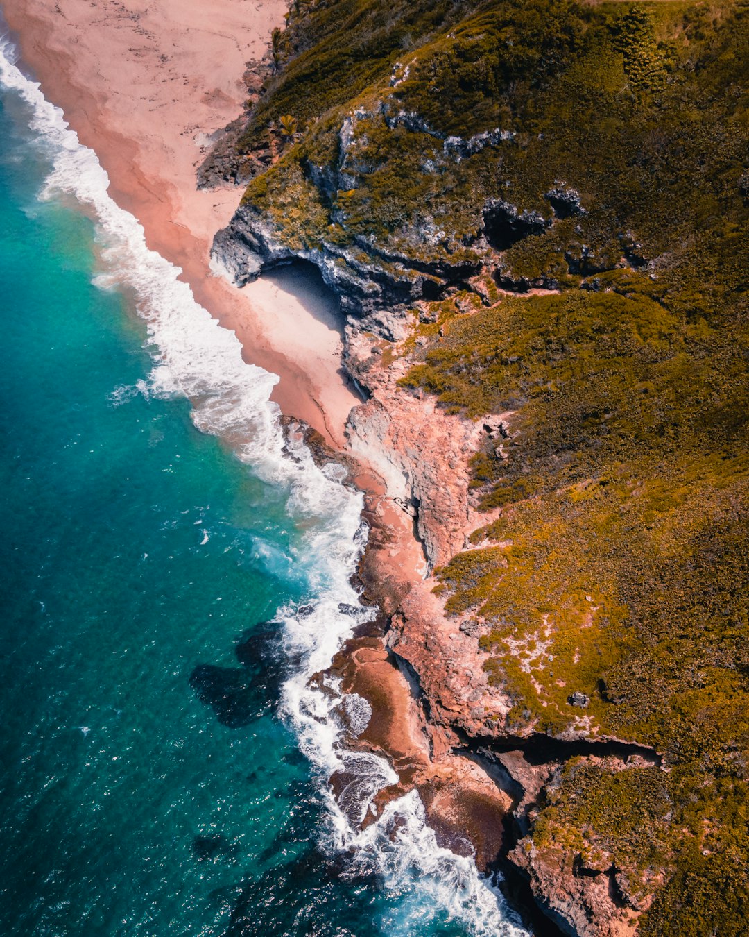 brown and green island beside body of water during daytime