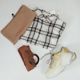 A flat lay of accessories paired with clothing items.