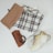 A flat lay of modest clothing items including a vest, inner top, and loose pants on a neutral background.