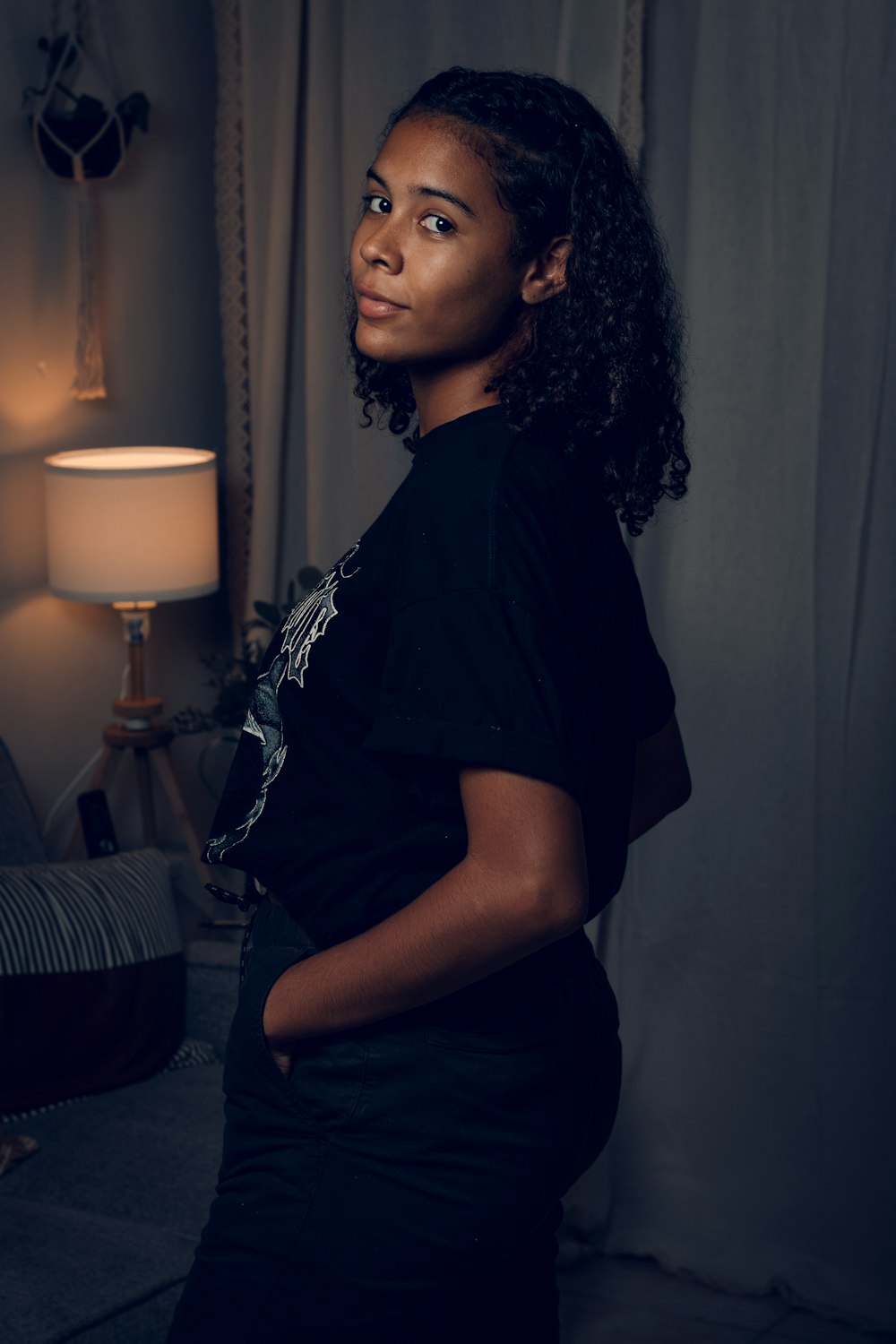 woman in black t-shirt sitting on bed