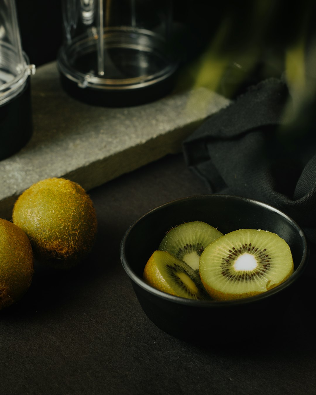 yellow round fruit on black ceramic bowl