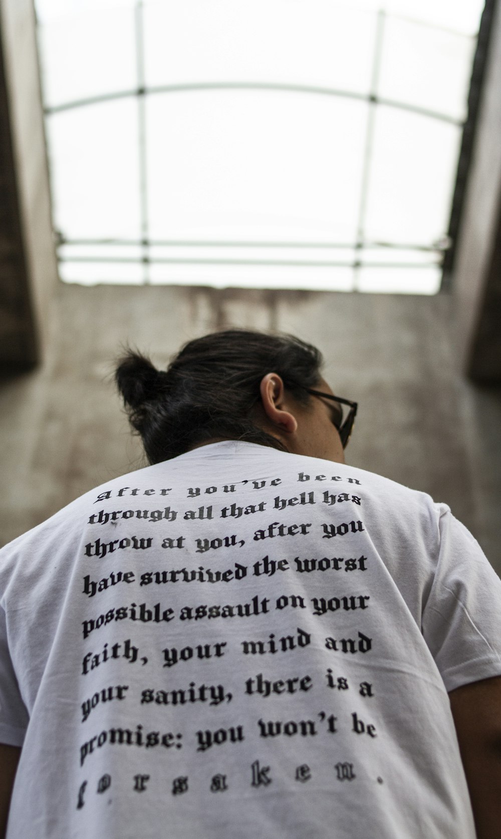 a person wearing a white shirt with a poem on it