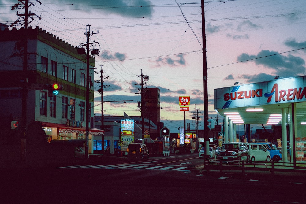 cars parked in front of store during night time