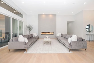 A sleek, modern living room featuring minimalist linear furniture in neutral tones.
