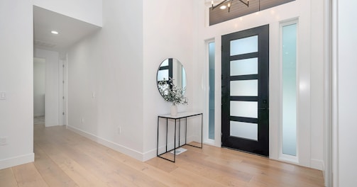 black round wall mirror on white wall