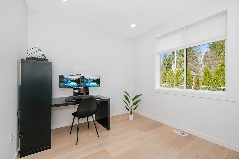 black flat screen tv on black wooden table